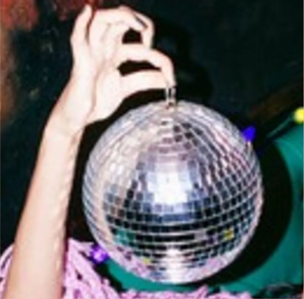 A guest holding a mirror ball at an AF Theatricals event