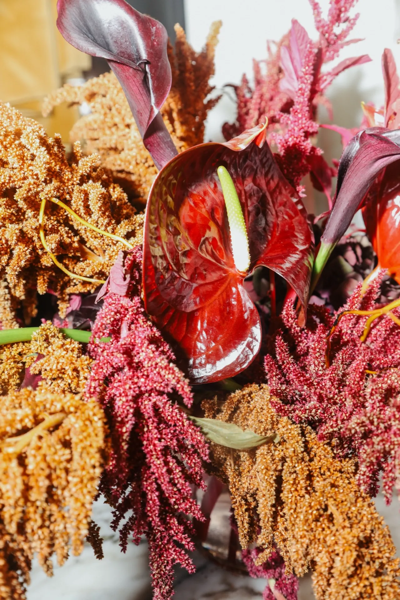 Autumn florals arranged in a silver urn