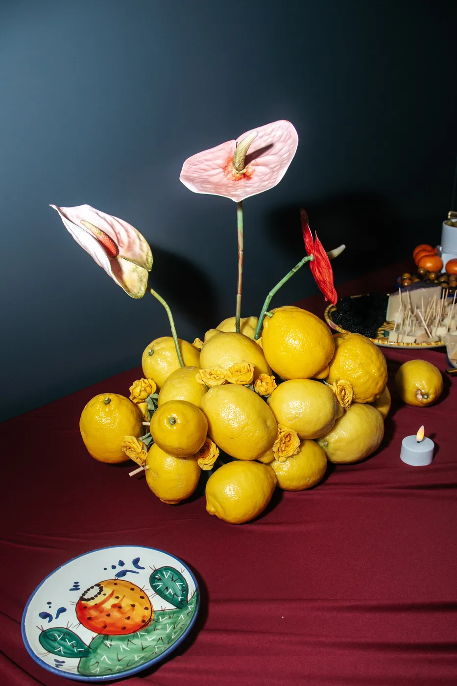 A sculptural lemon and anthurium centerpiece